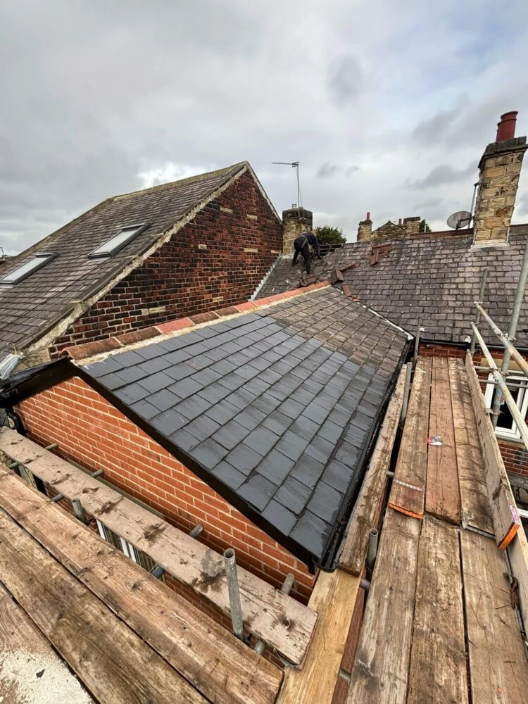 Newly slated rear extension roof with scaffold boards still in place